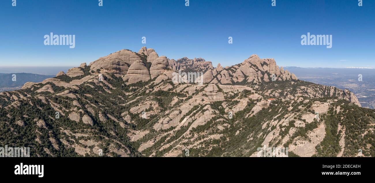 Panoramic aerial drone shot of Top of Montserrat mountain range in morning time near Barcelona Stock Photo