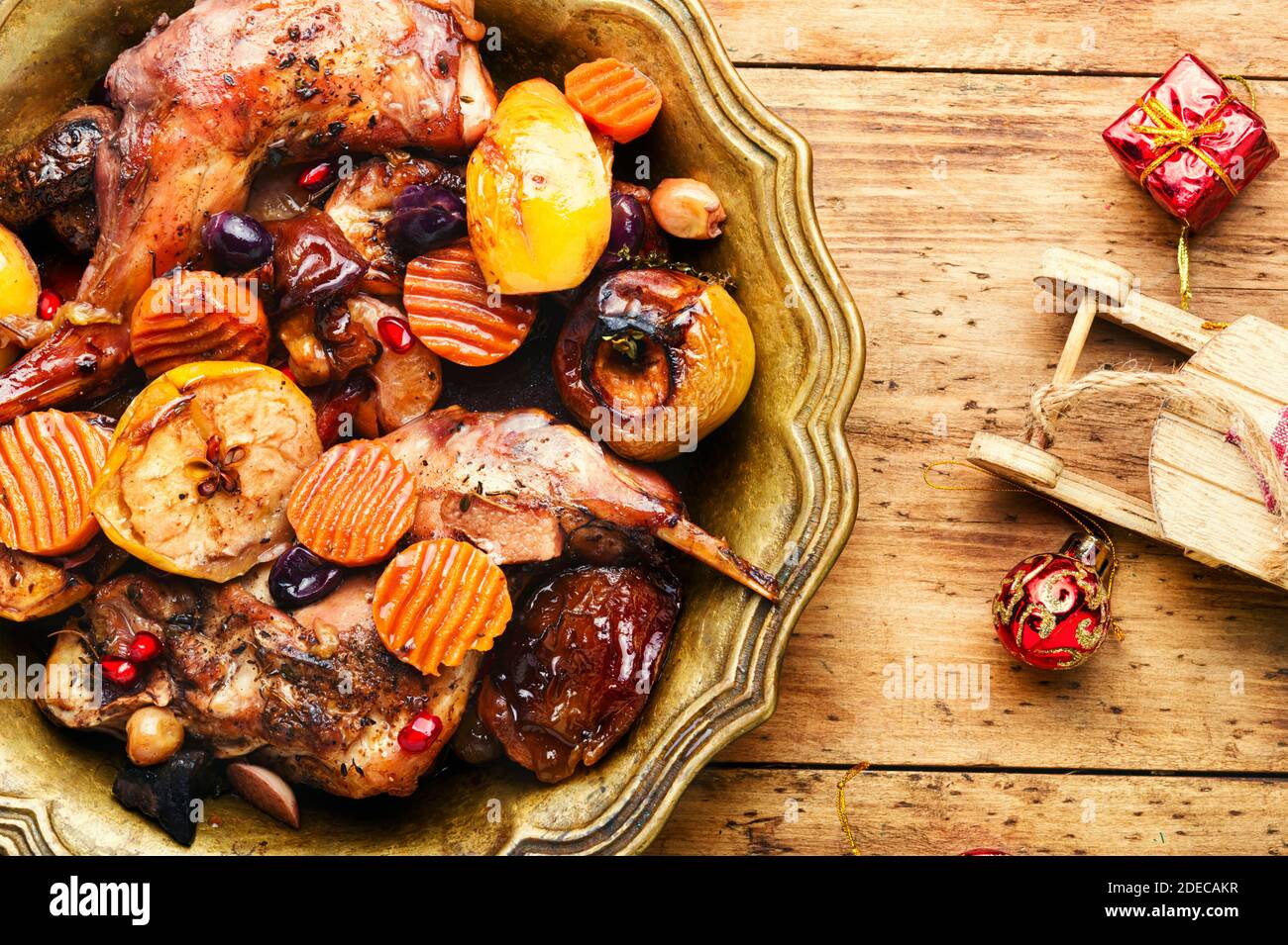 Braised rabbit meat with fruits.Baked meat for the Christmas table. Christmas dish. Stock Photo