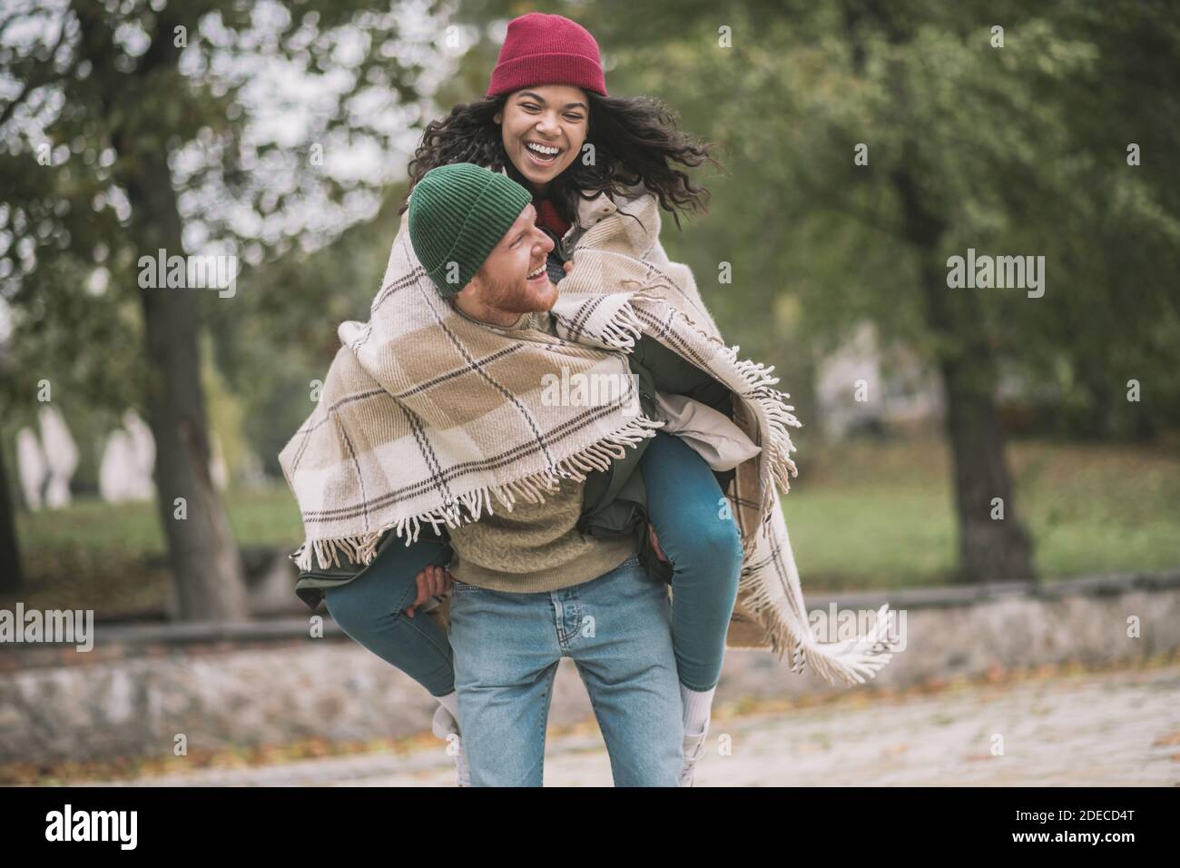 Woman sitting on mans back hi-res stock photography and images - Alamy