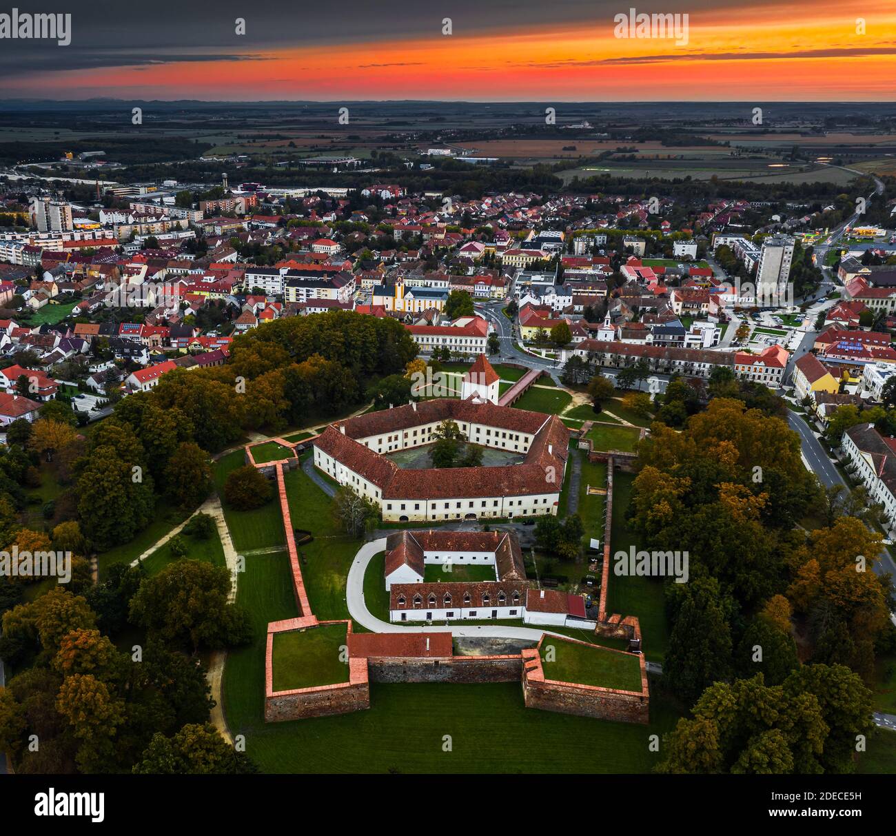 Sarvar, Hungary - Aerial panoramic view of the Castle of Sarvar (Nadasdy castle) at autumn from high above with a beautiful dramatic sunrise at backgr Stock Photo