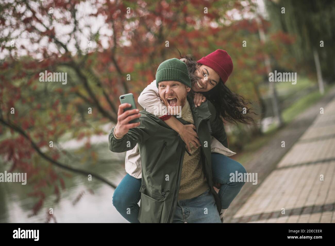 Joyful couple making crazy and emotional selfies Stock Photo