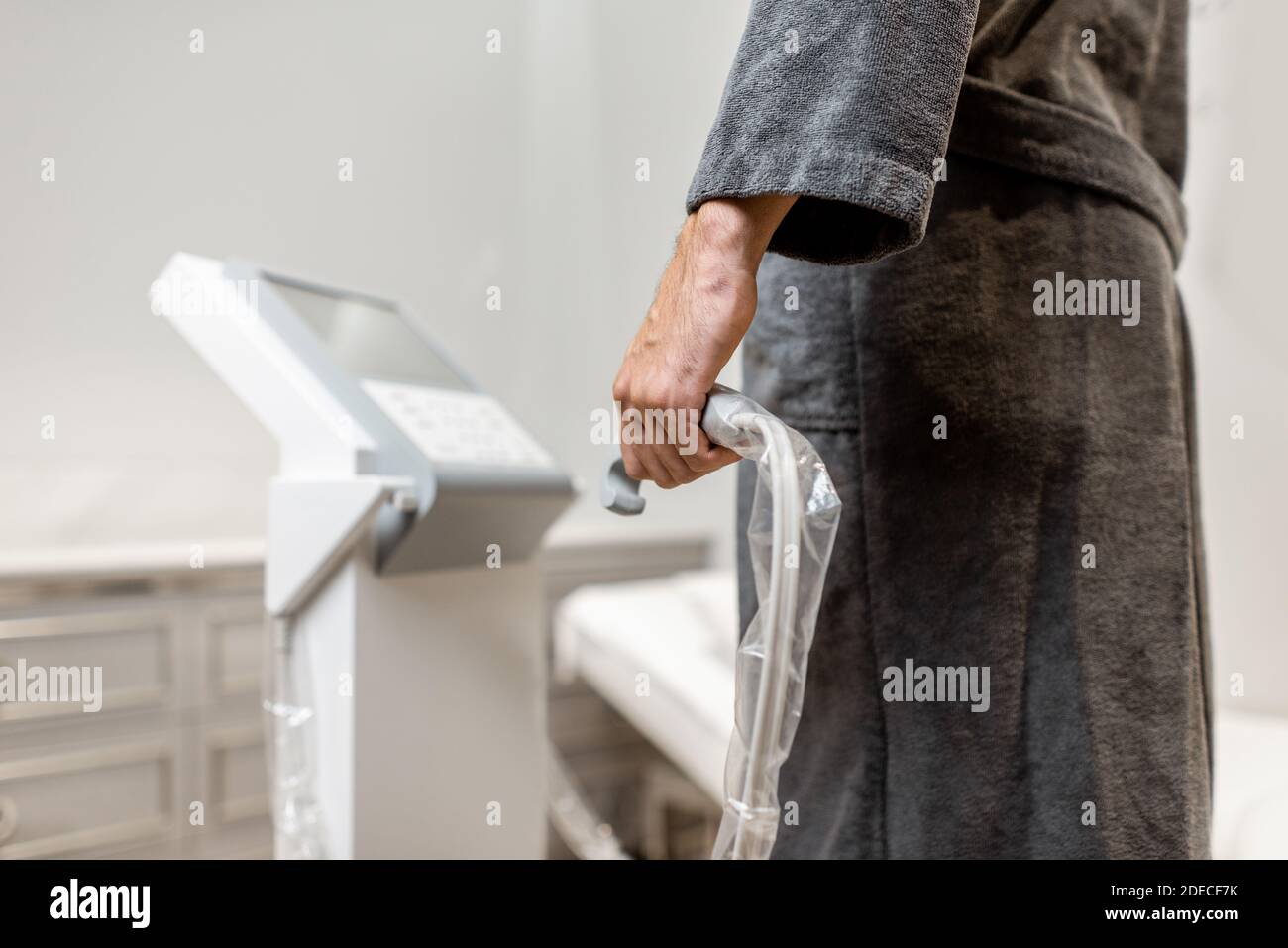 Man measuring body composition balance, holding handles of a medical scales during Inbody test