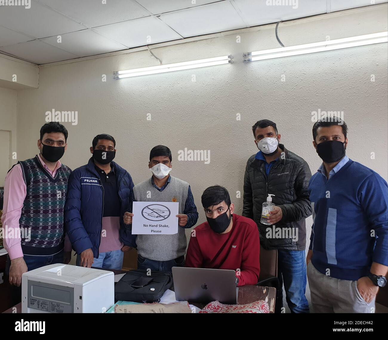 India 02 January 2020 Coronavirus: A group of employees covered with masks. A message to be secure and save other. Coronavirus is war, let we be separ Stock Photo