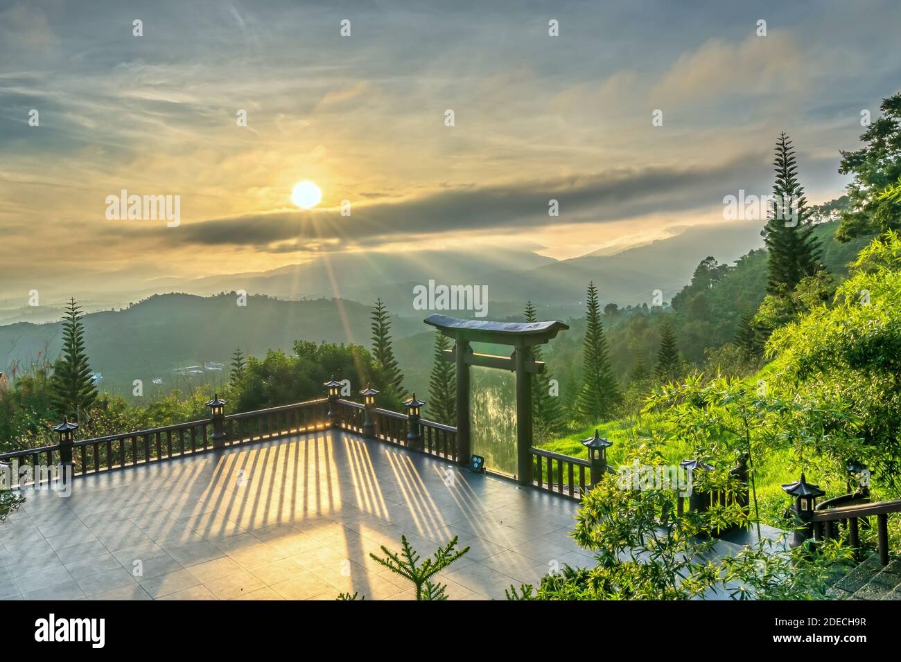 The magical sunrays of dawn next to the lantern in front of the temple yard welcomes the beautiful new day Stock Photo