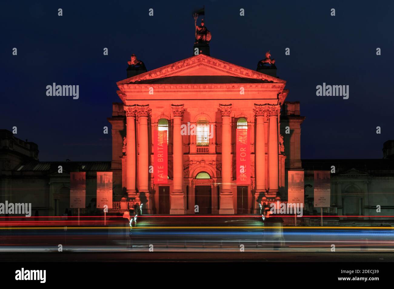 Tate Britain exterior from Milbank, night long exposure with light trails, London, UK Stock Photo