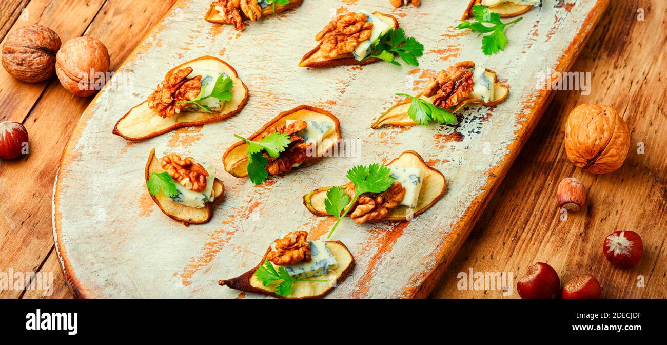 Dry pear,blue cheese and walnut appetizer.Seasonal snack Stock Photo