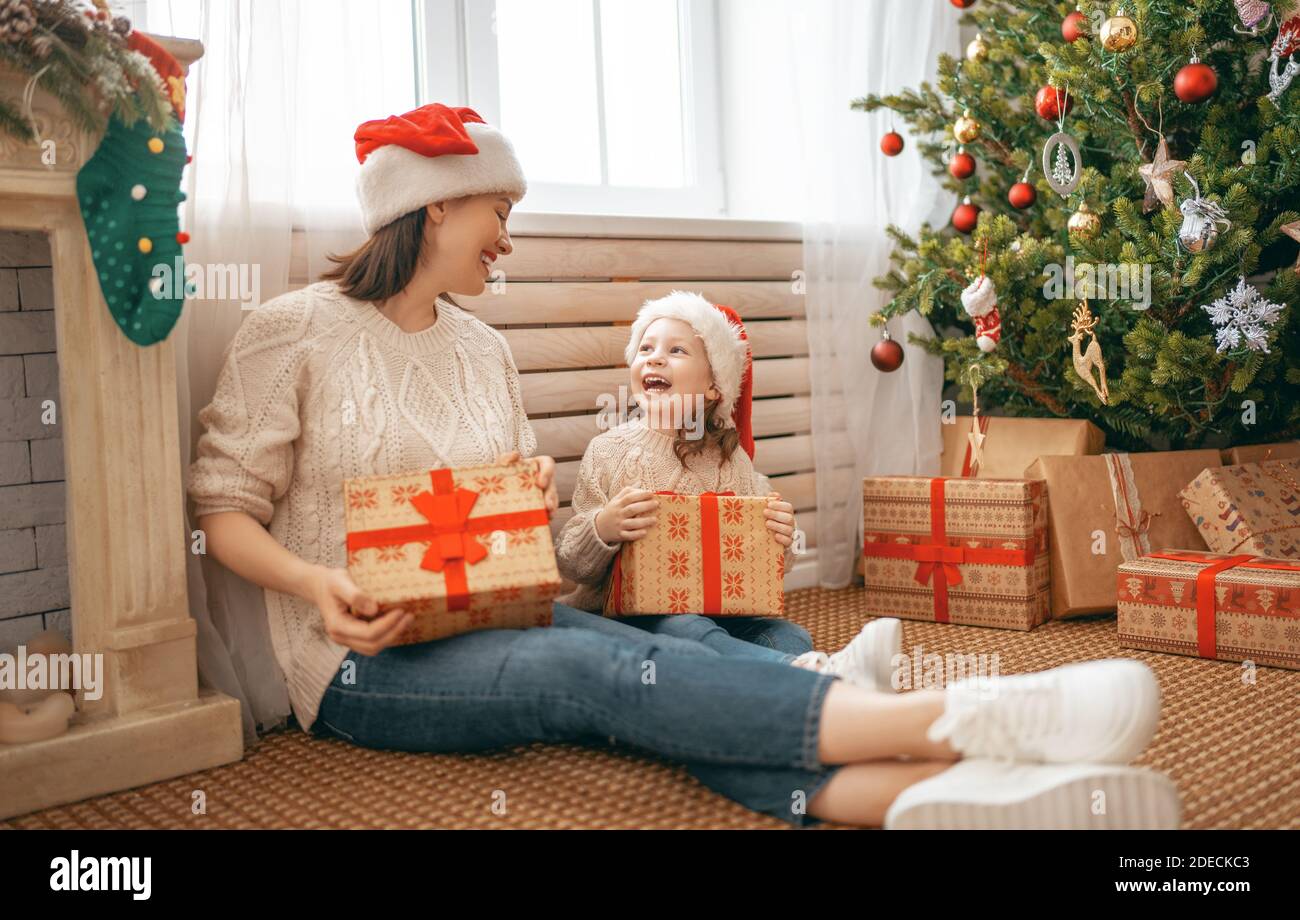 Merry Christmas and Happy Holidays! Cheerful mom and her cute daughter