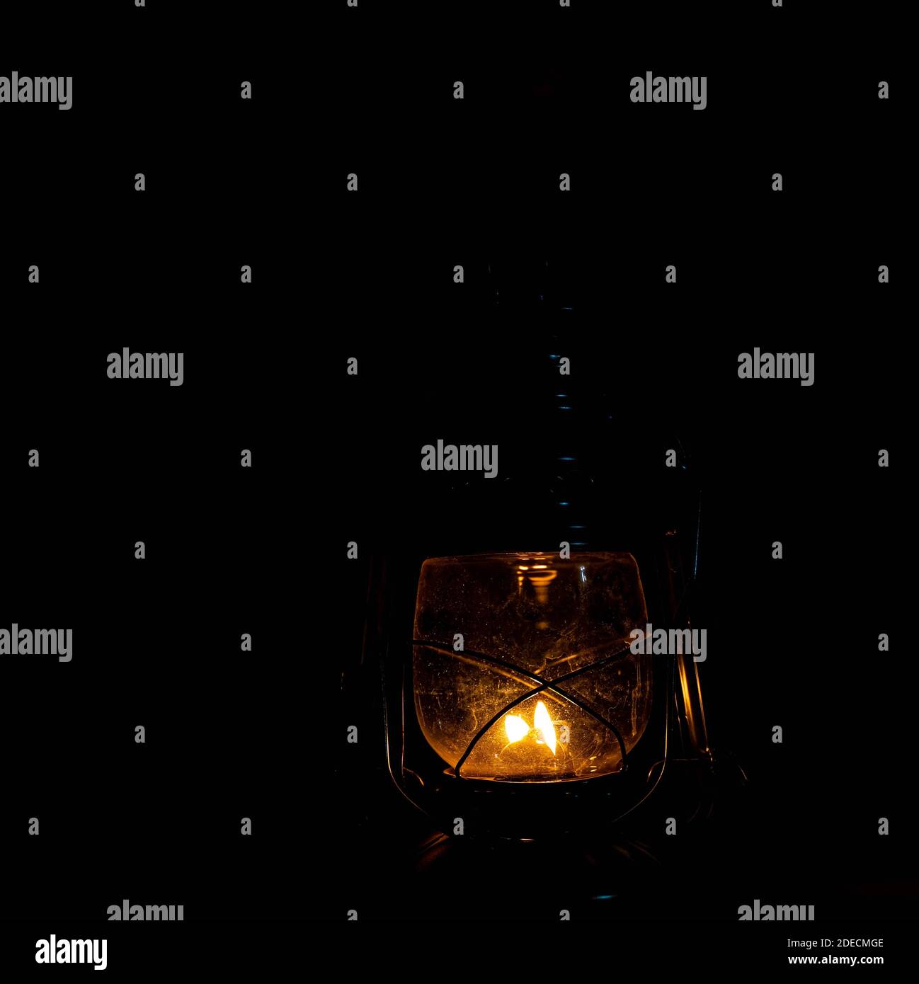 https://c8.alamy.com/comp/2DECMGE/vintage-metal-kerosene-lamp-lighting-up-a-dark-place-with-warm-light-high-quality-photo-2DECMGE.jpg