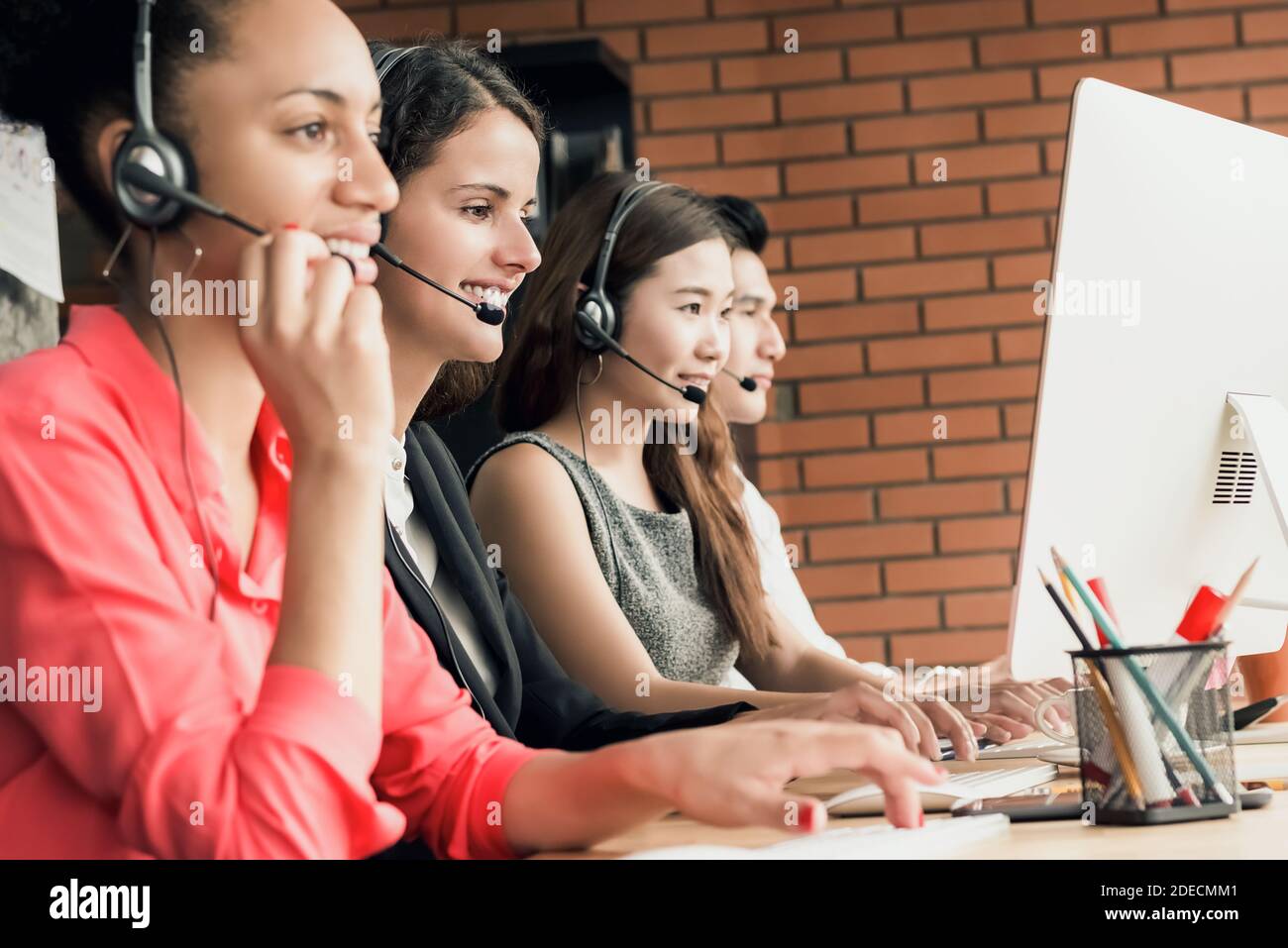 International call center telemarketing customer service agent team working in the office Stock Photo