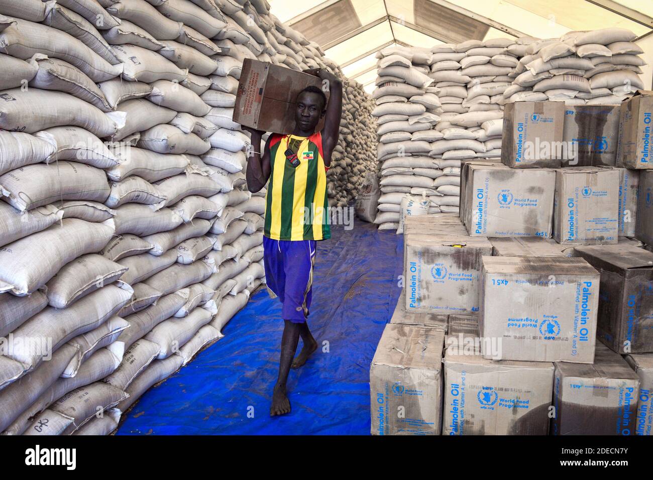A man prepares food rationing for refugees to Kule refugee camp in Ethiopia due to the clashes between South Sudanese government forces and South Suda Stock Photo