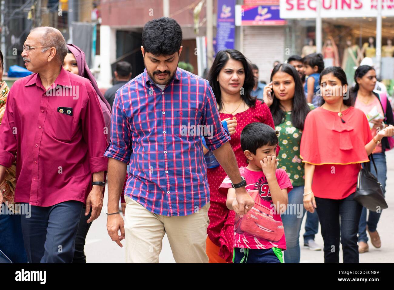 Bangalore, India - August 12, 2018: Indian family walks this morning at commercial street, a hotspot for shopping in the city. Stock Photo