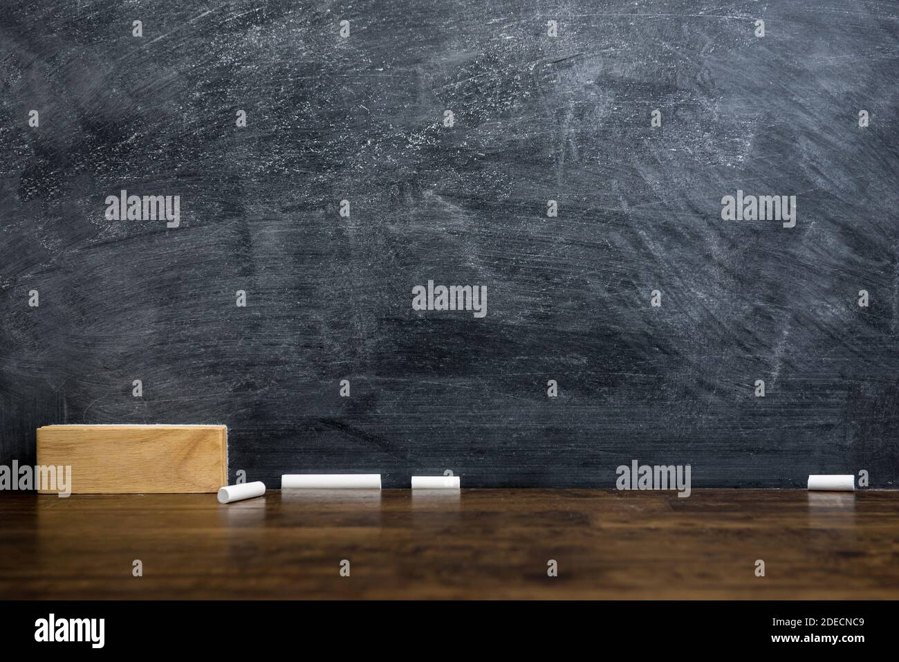 Empty blackboard or chalkboard with eraser and chalk on the table - education background concept Stock Photo