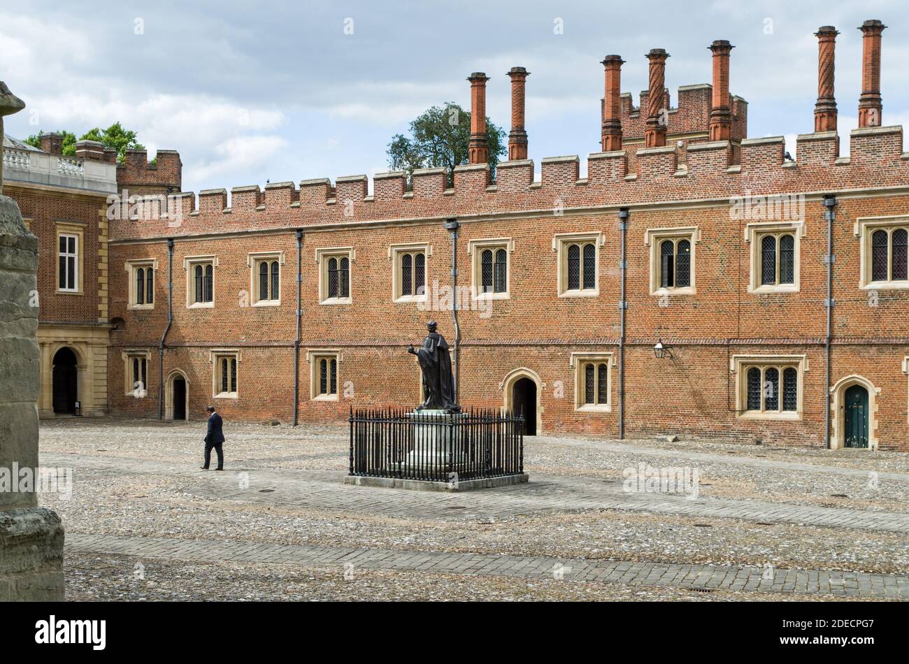 Eton College, a public school for boys, Eton, Berkshire, UK; view of the quadrangle with master waling across. Stock Photo