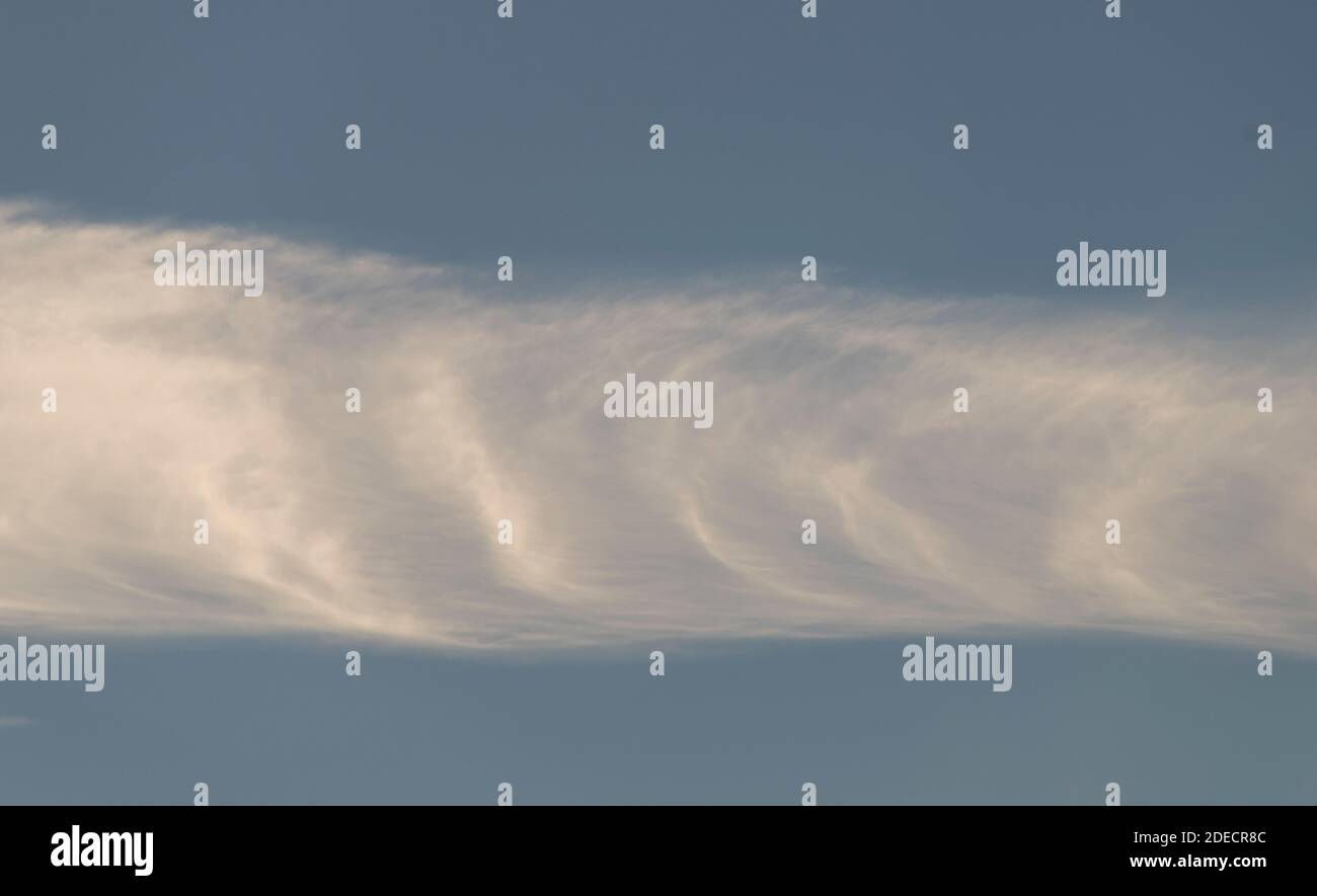 Linear horizontal banded strip of cloud (possibly Kelvin- Helmholz cloud). Winter,  Queensland, Australia. Background, copy space. Stock Photo