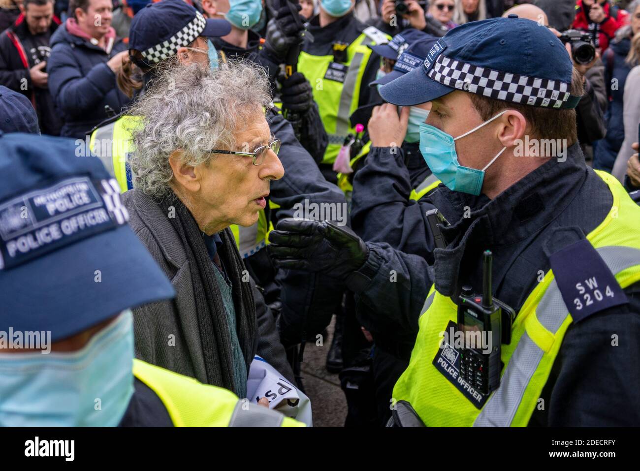 Piers Corbyn surrounded by police officers at an anti lockdown protest in London, UK. Corbyn was later arrested. Illegal gathering, rally, march Stock Photo