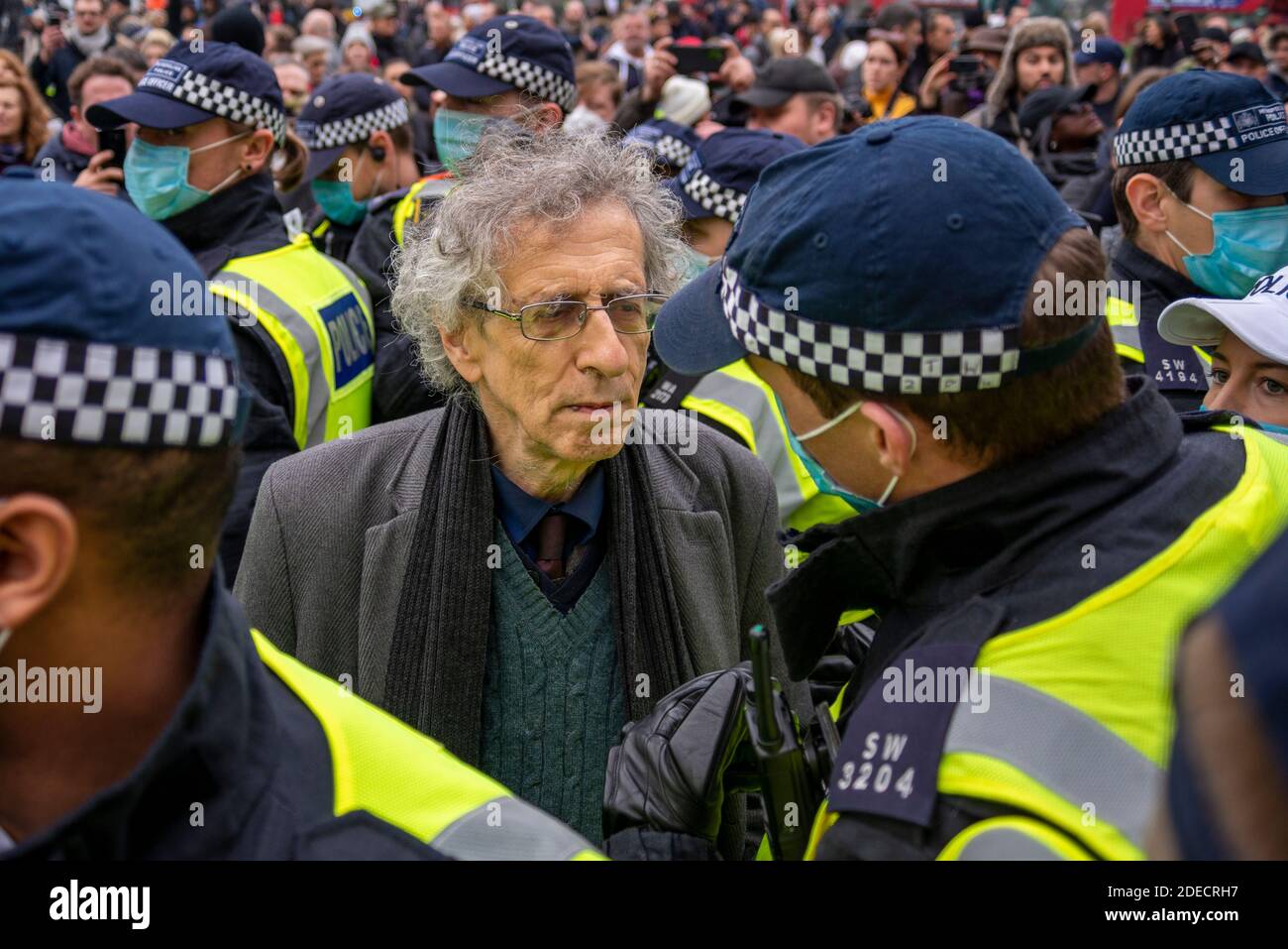 Piers Corbyn surrounded by police officers at an anti lockdown protest in London, UK. Corbyn was later arrested. Illegal gathering, rally, march Stock Photo