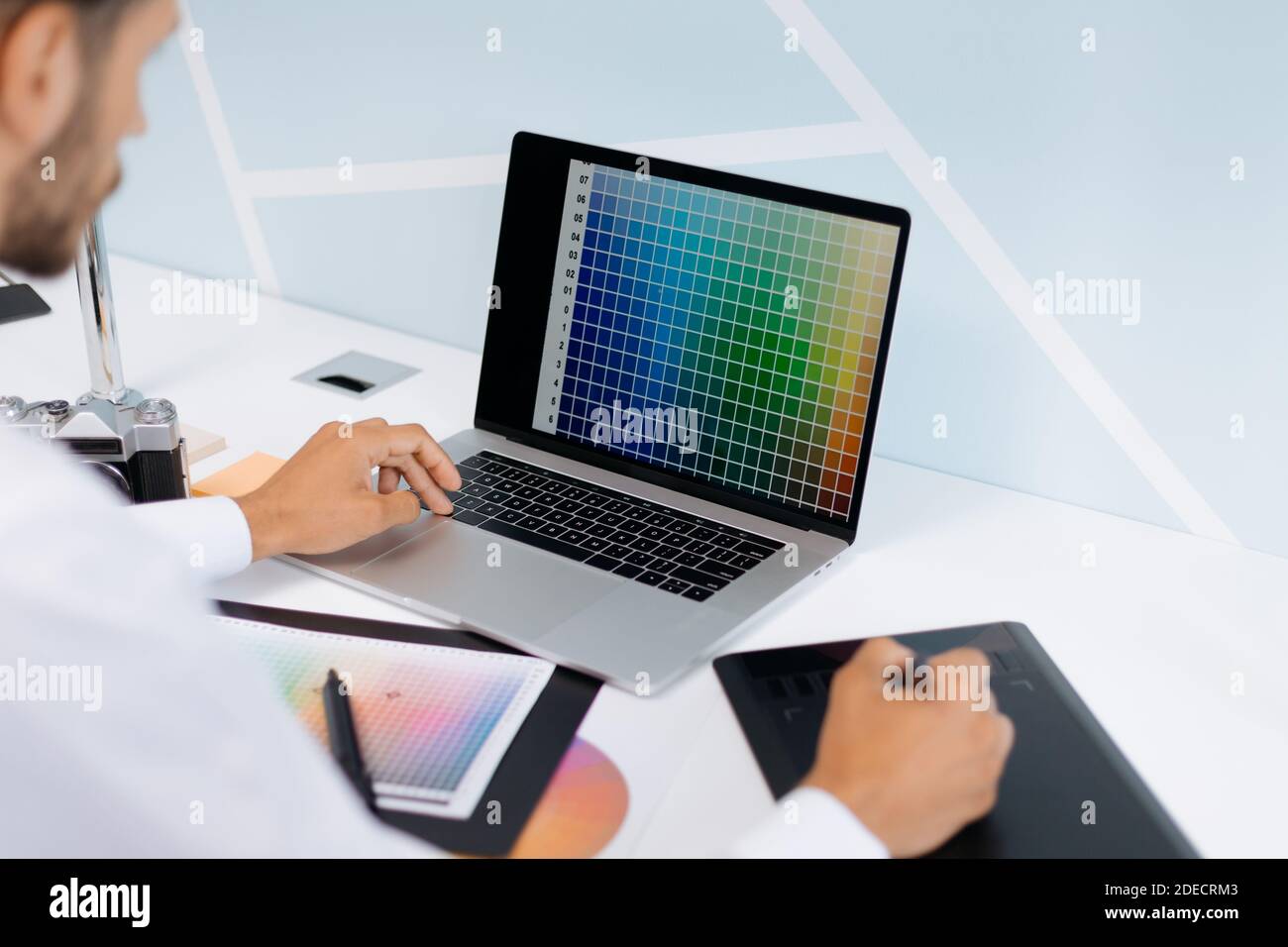 designer works on a computer and a graphic tablet at the same time. Stock Photo