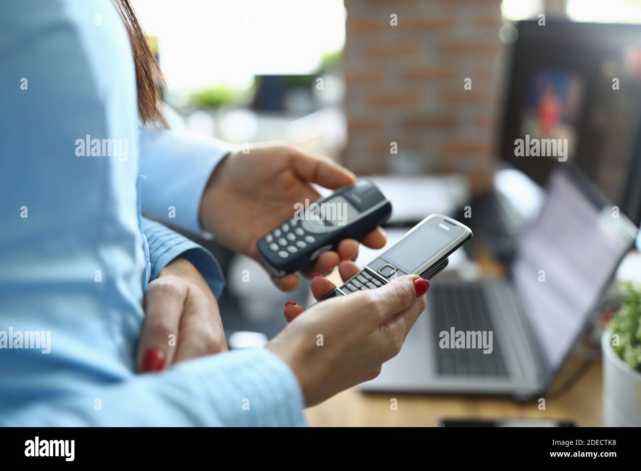 Two business people partners hol button vintage phone nokia 8800 and 3310 in hands closeup Stock Photo