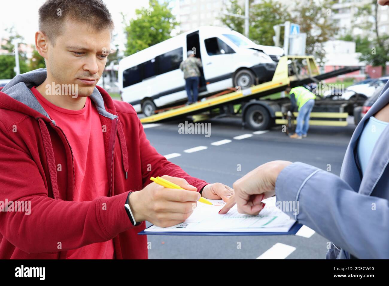 Insurance agent gives driver to sign documents after accident Stock ...