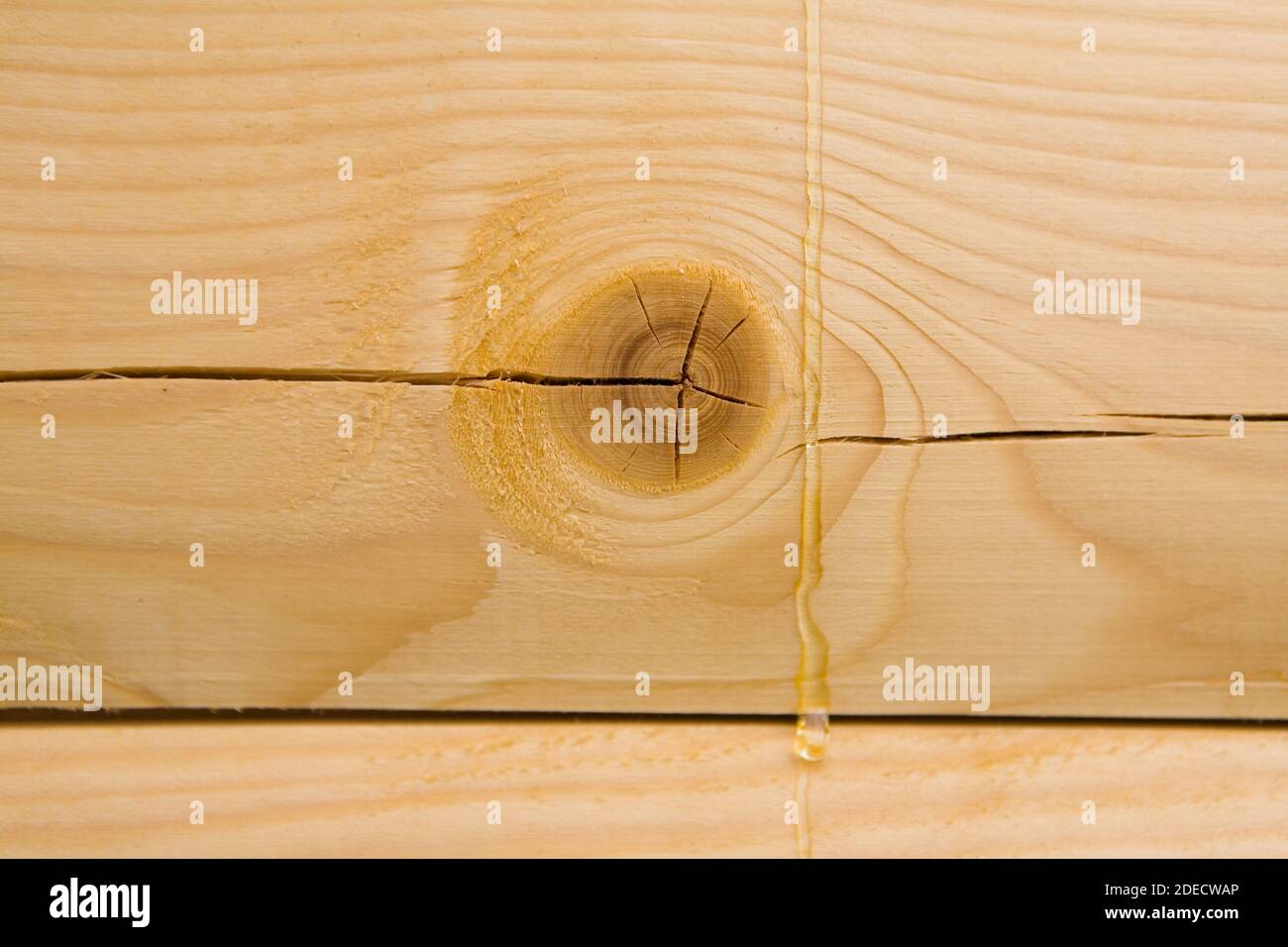 The resin flows over the treated wooden beam. Close-up. Stock Photo