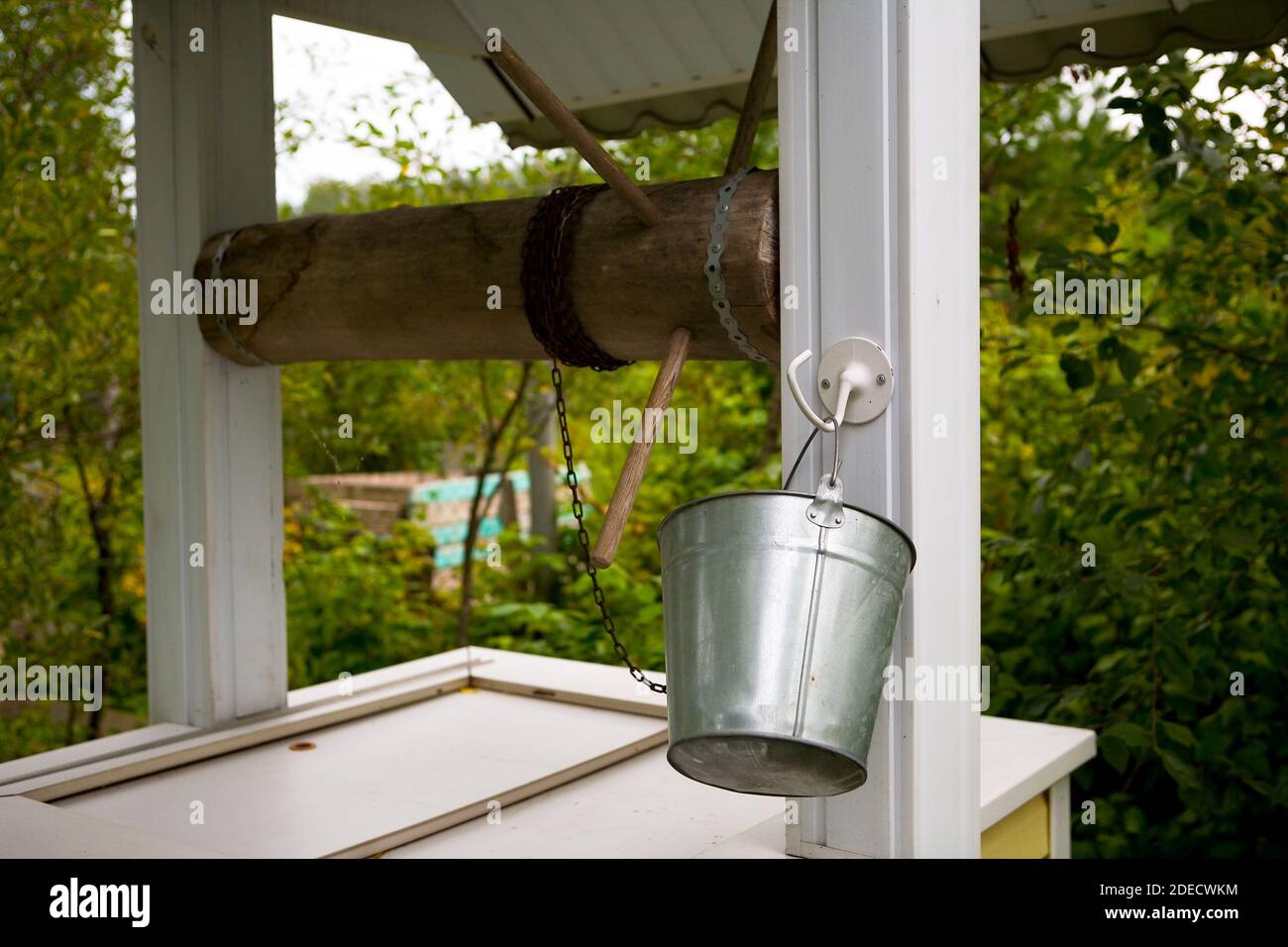 Country well with a bucket on a chain. Rural life. Stock Photo