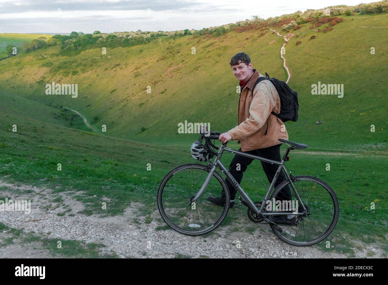 Young man walking his bike at Devils Dyke just outside of Brighton & Hove, East Sussex, UK Stock Photo