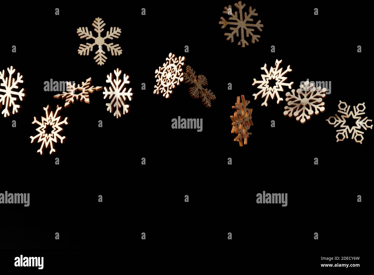 Snowflake pattern with falling snowflakes and space for text on a black background Stock Photo