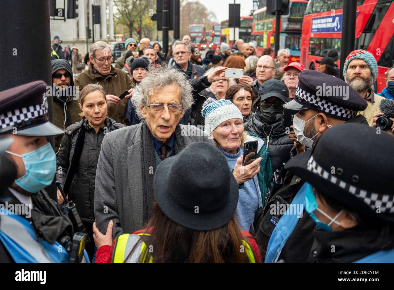 Piers Corbyn being stopped by police liaison officers at an anti lockdown protest in London, UK. Corbyn was later arrested Stock Photo