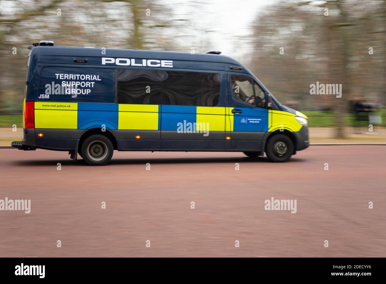 Police Territorial Support Group van rushing to react to protesters at an anti lockdown protest in London, UK. Vehicle driving at speed on The Mall Stock Photo