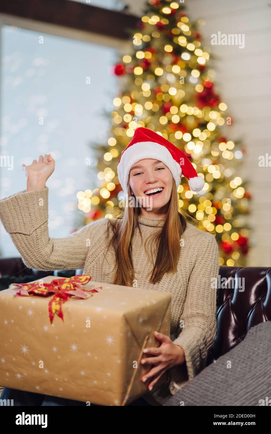 Girl holding a Christmas present on New Years Eve Stock Photo - Alamy