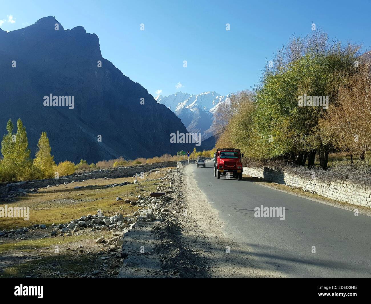 India 03 june 2020 kargil road a tipper is running on background hills green plants Stock Photo