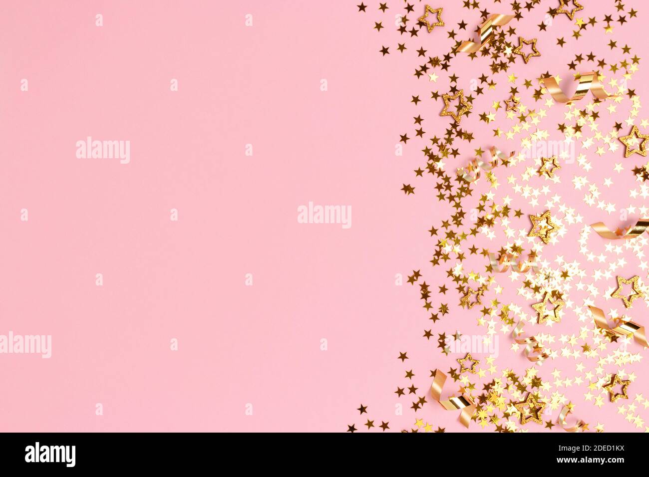 Gold stars confetti on a pink pastel background. Shiny concept with ...