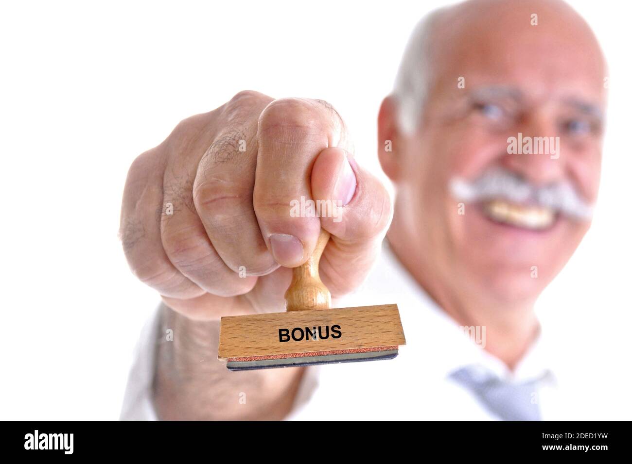 old man with stamp in his hand lettering Bonus, Germany Stock Photo