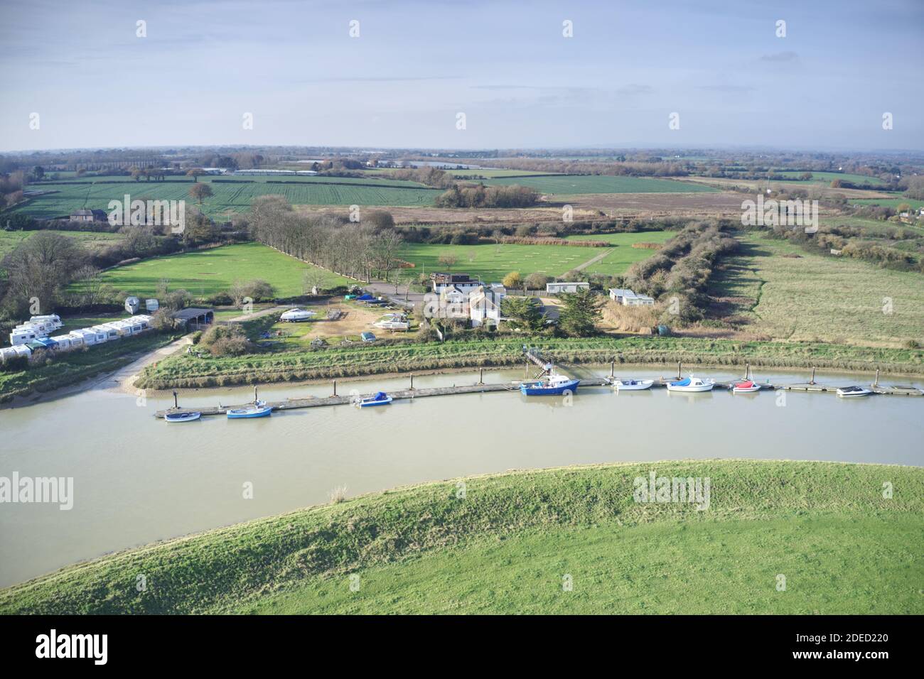 River Arun near Ford in West Sussex with boats moored on a curve in the