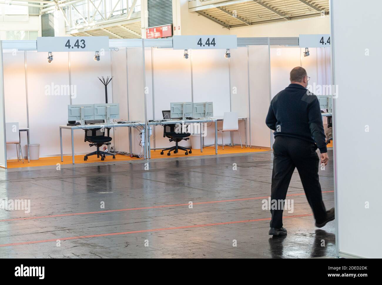 Munich, Germany. 30th Nov, 2020. A man walks through the still empty Contact Tracing Center that was set up in the Messe Riem. Credit: Peter Kneffel/dpa/Alamy Live News Stock Photo