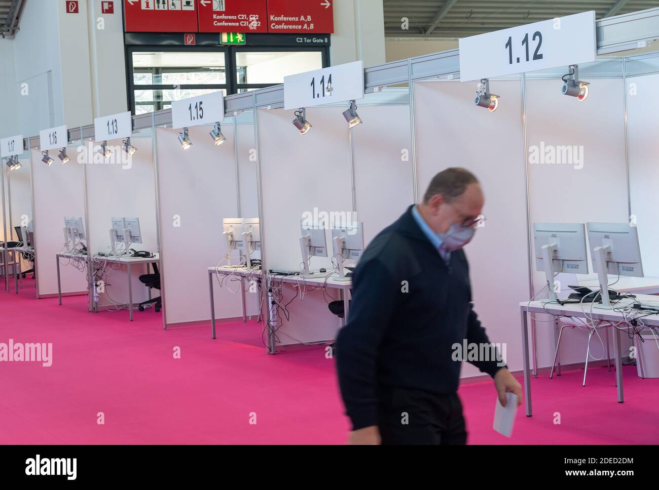 Munich, Germany. 30th Nov, 2020. A man walks through the still empty Contact Tracing Center that was set up in the Messe Riem. Credit: Peter Kneffel/dpa/Alamy Live News Stock Photo