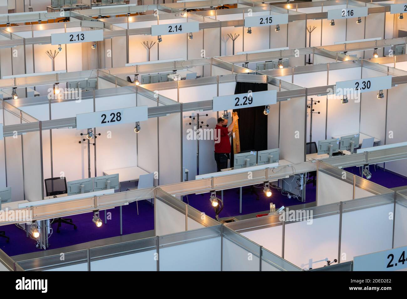 Munich, Germany. 30th Nov, 2020. A man puts the finishing touches to the still empty Contact Tracing Center that was set up at Messe Riem. Credit: Peter Kneffel/dpa/Alamy Live News Stock Photo