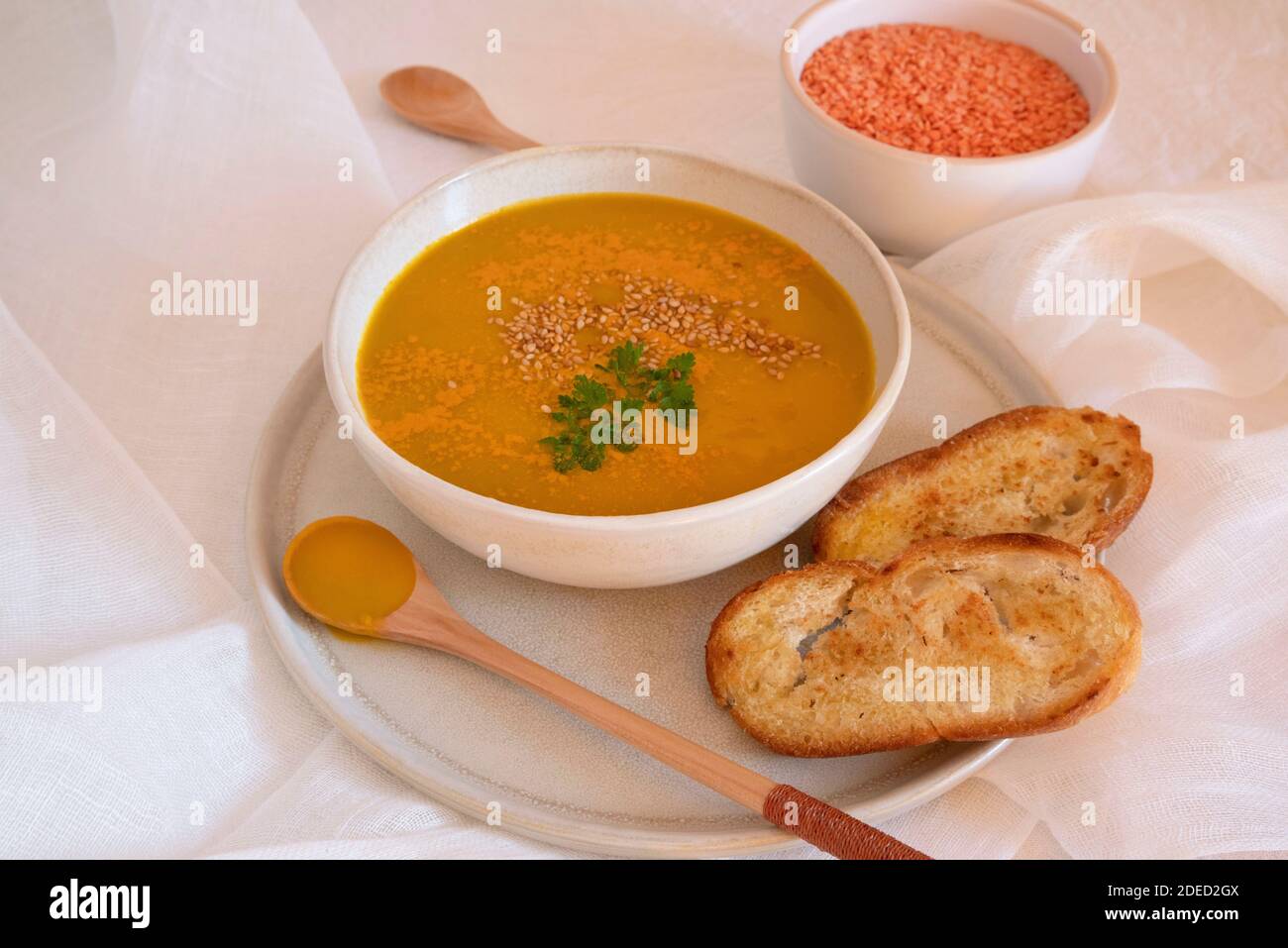 Orange soup in a bowl, pumpkin, carrot or coral lentils Stock Photo