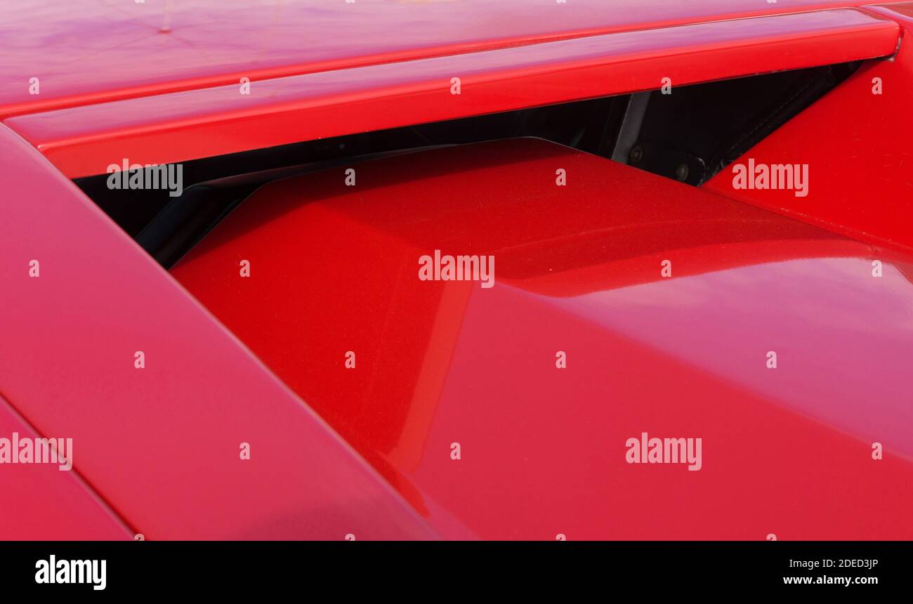 Close up detail of the rear window and engine cover of a red Countach 25th