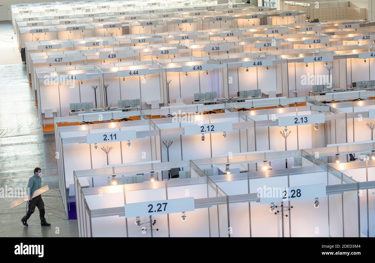 Munich, Germany. 30th Nov, 2020. A man walks through the still empty Contact Tracing Center. The booths have been set up in Hall C2 of Messe Riem. Credit: Peter Kneffel/dpa/Alamy Live News Stock Photo