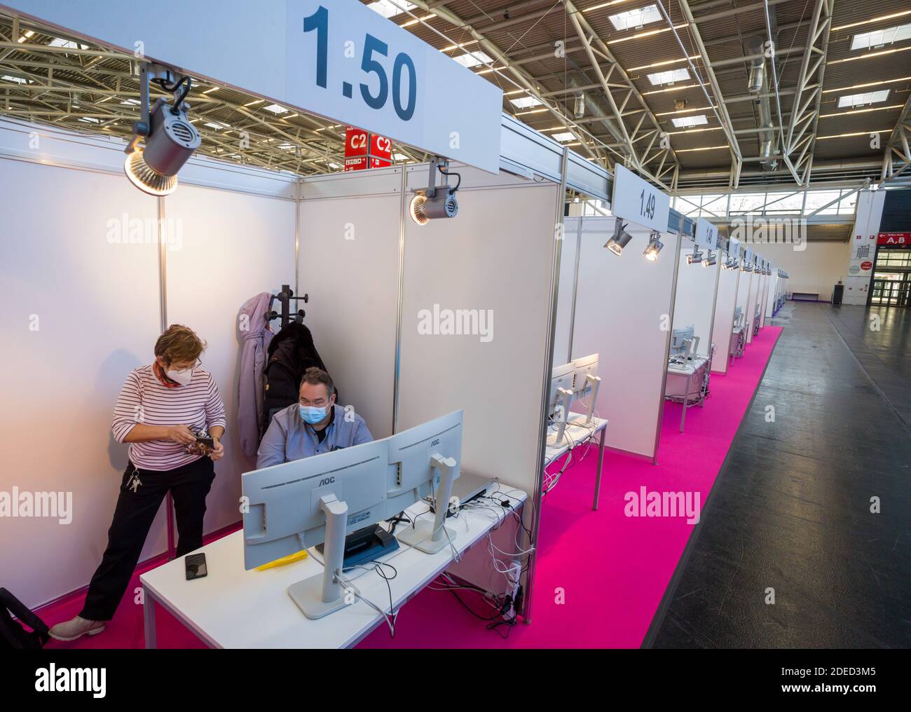 Munich, Germany. 30th Nov, 2020. Two employees work in the still empty Contact Tracing Center. The booths have been set up in Hall C2 of Messe Riem. Credit: Peter Kneffel/dpa/Alamy Live News Stock Photo