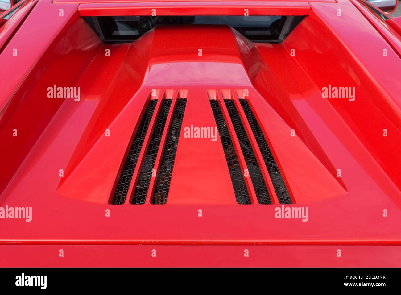 Close up detail of the rear window and engine cover of a red Countach 25th