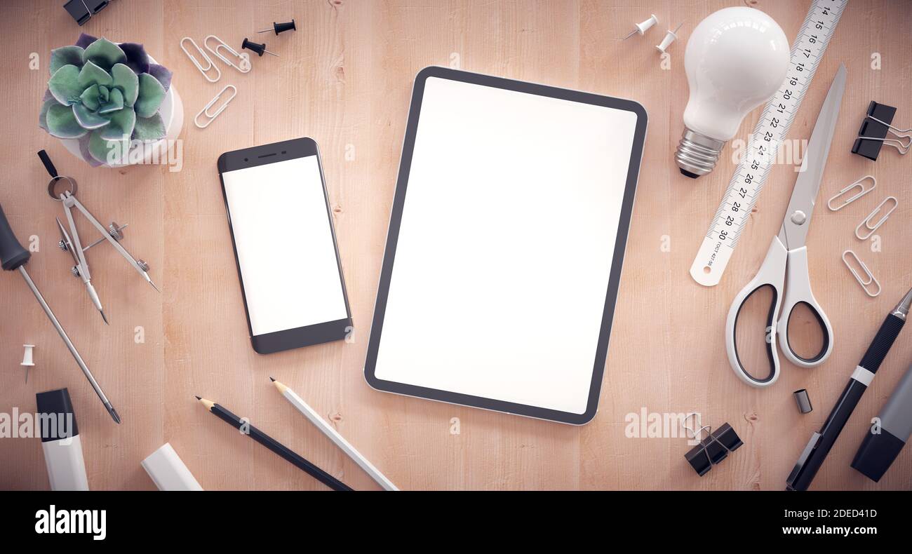 Responsive web design development. Work table with tablet, smartphone and other office items. Stock Photo