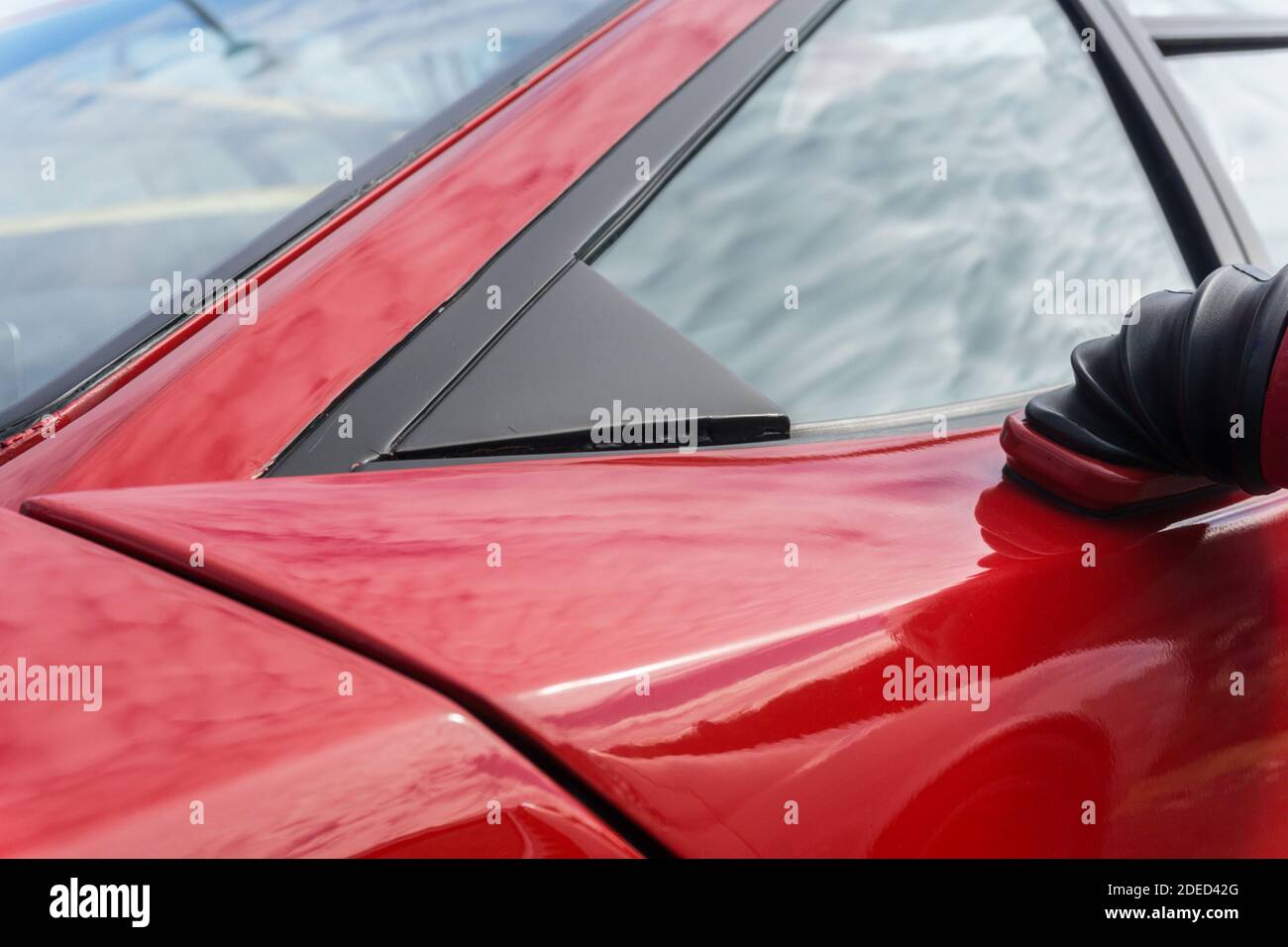 Close up detail of the door and side windows on a red