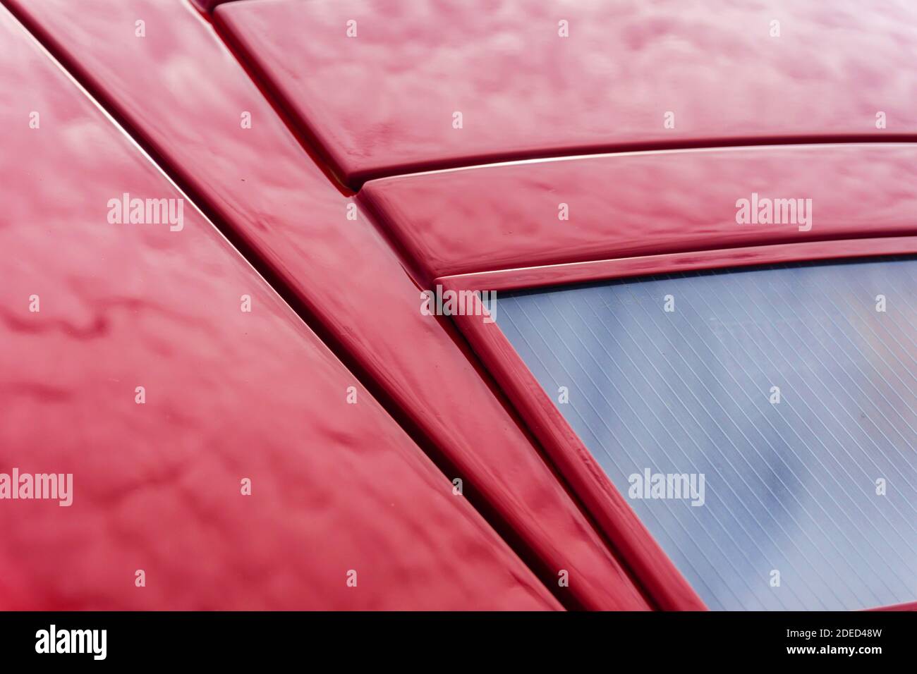 Close up detail of the headlights and bodywork on a red