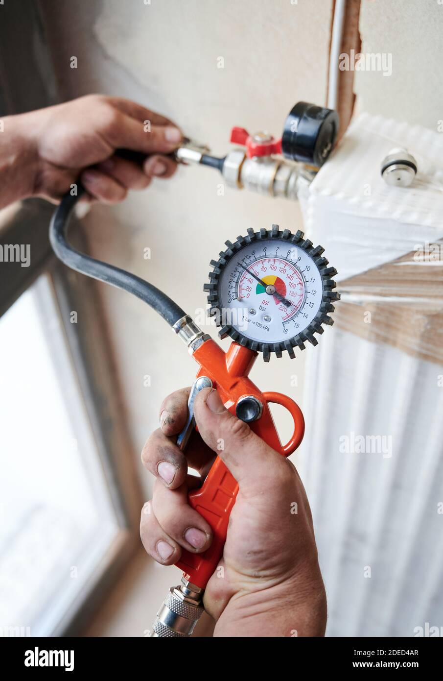 Plumber installing pressure meter house hires stock photography and