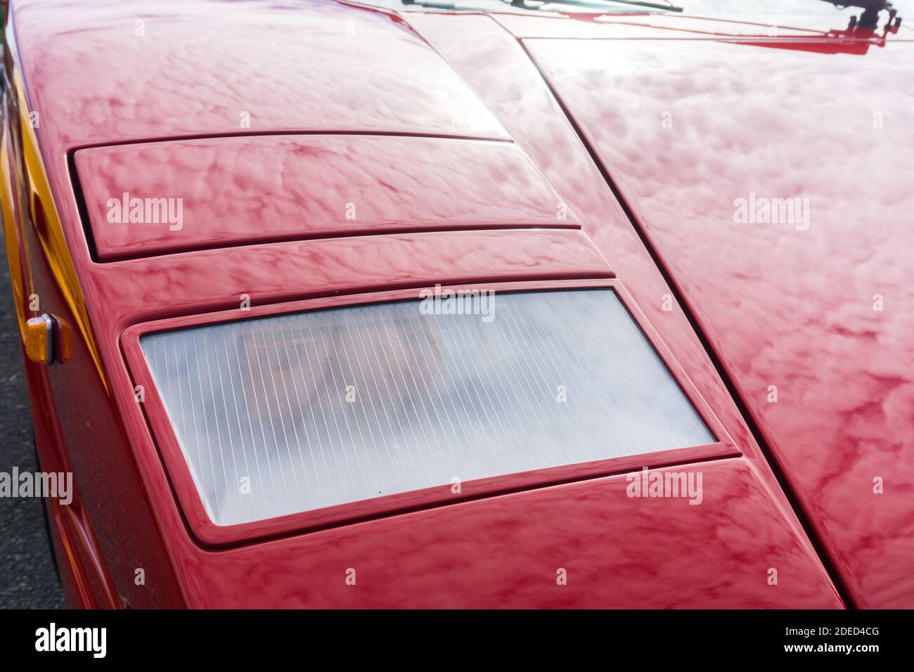 Close up detail of the headlights and bodywork on a red