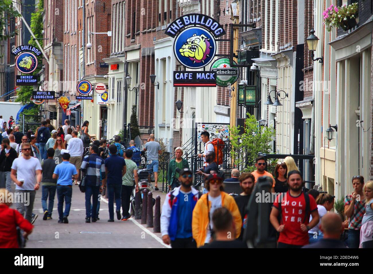 AMSTERDAM, NETHERLANDS - JULY 10, 2017: People visit The Bulldog coffee shop in Amsterdam, Netherlands. Coffeeshops legally sell marijuana for persona Stock Photo