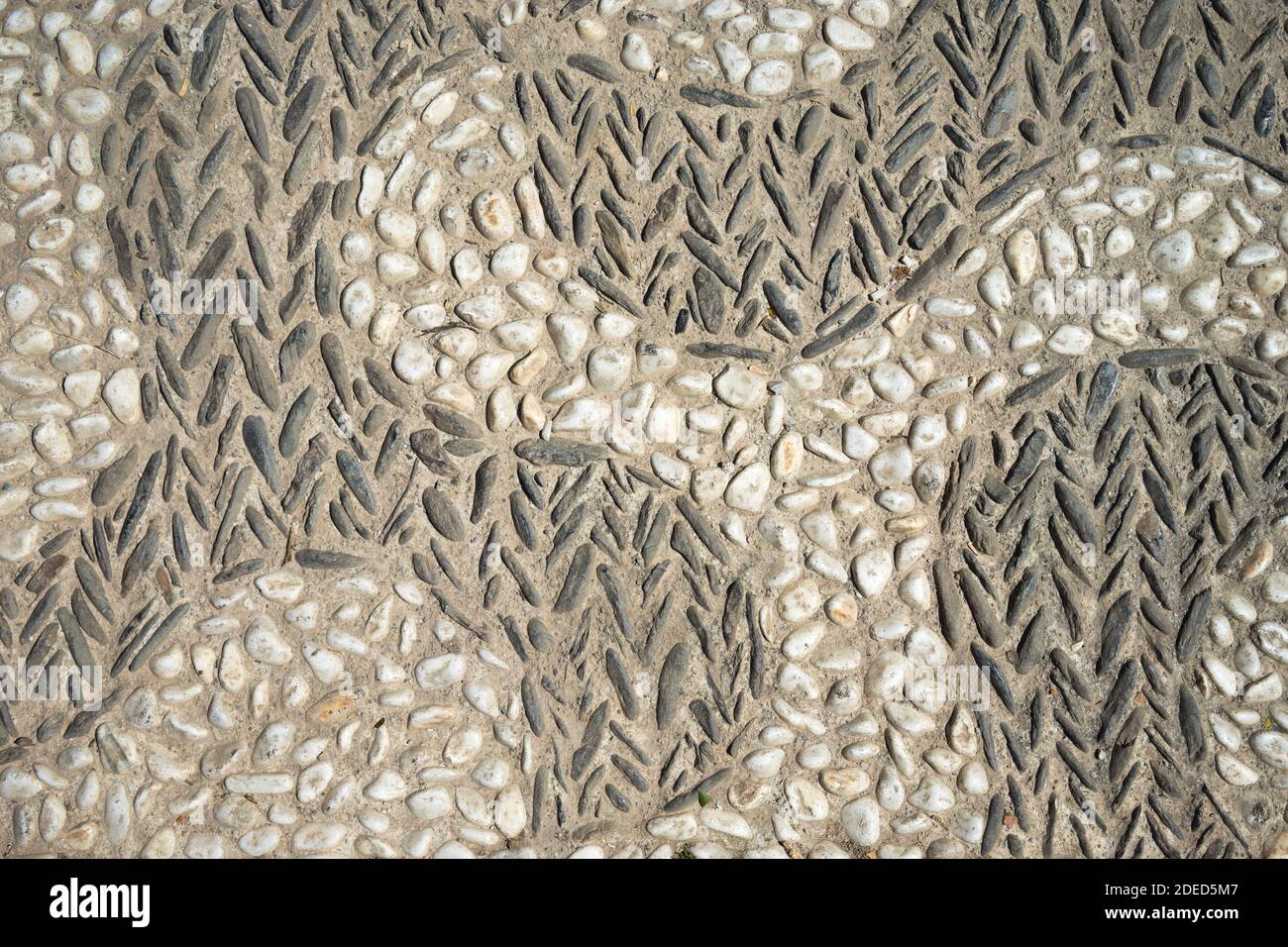 old natural stone pavement background, wall with pebbles stone texture Stock Photo