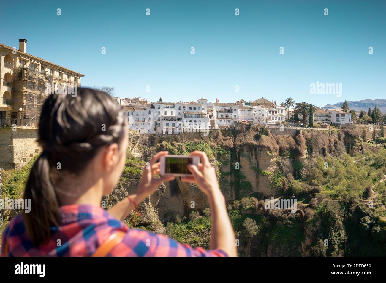 Woman traveler taking photo of the old city and of Ronda, one of the most famous white villages of Malaga, Andalusia, Spain Stock Photo
